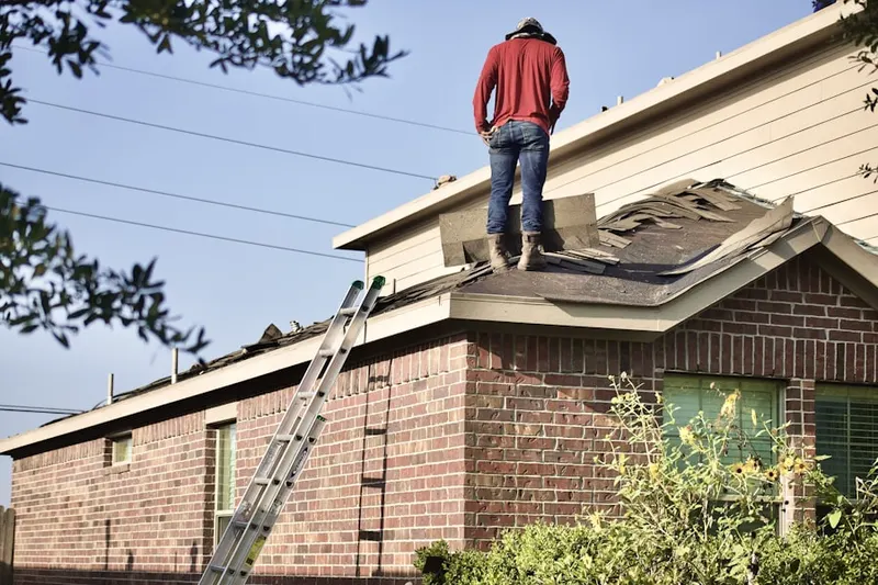 Professional roofer working on a residential roof in South of Conant